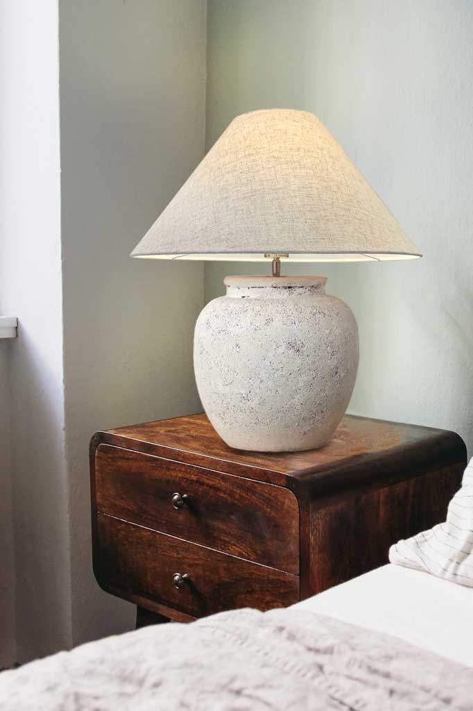 ceramic table lamp sandstone and paired with a fabric drum shade with a natural flax finish.