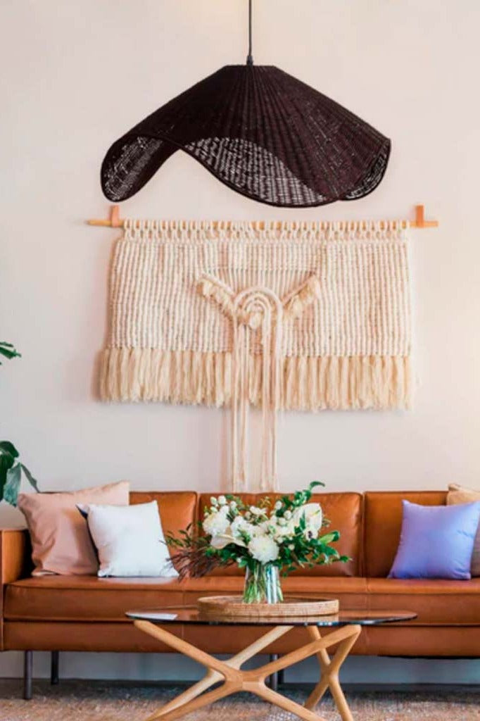 Chic brown pendant light over a table.