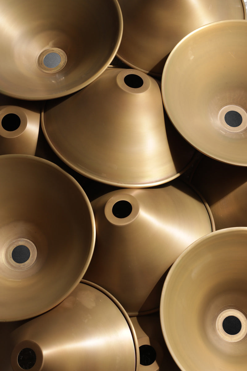 Aged brass cone shades close up