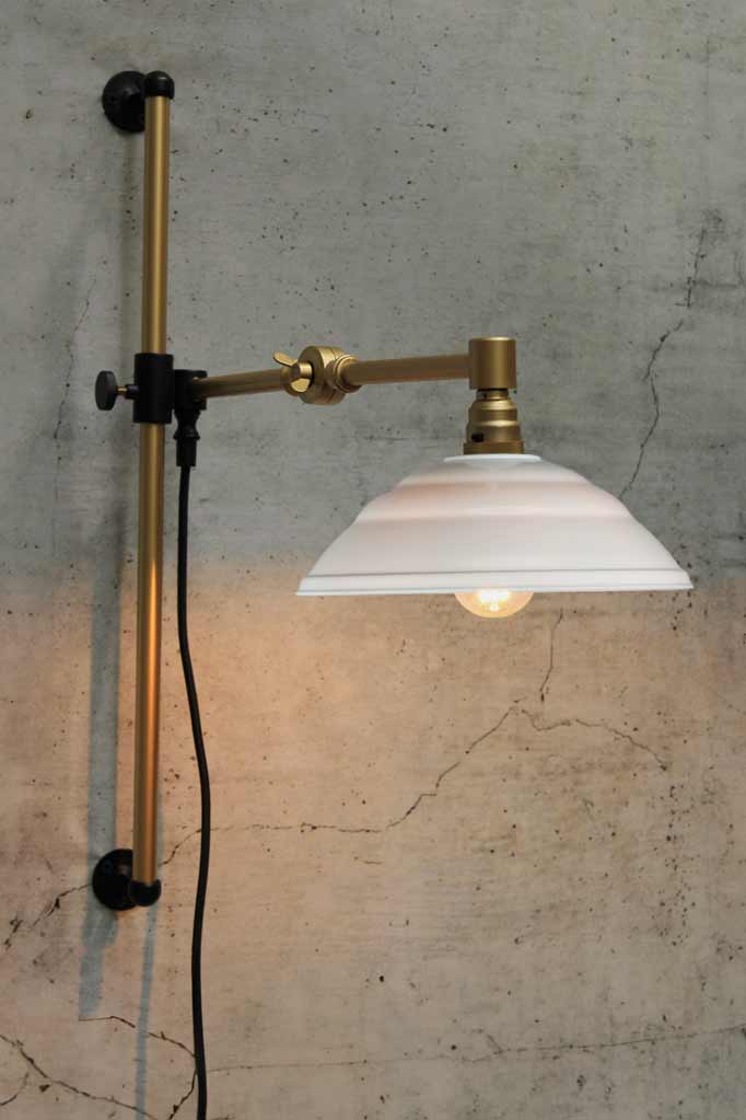 Swing Arm Wall Lamp in gold arm finish with white Bakelite shade