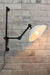 Swing Arm Wall Lamp in black finish with white Bakelite shade