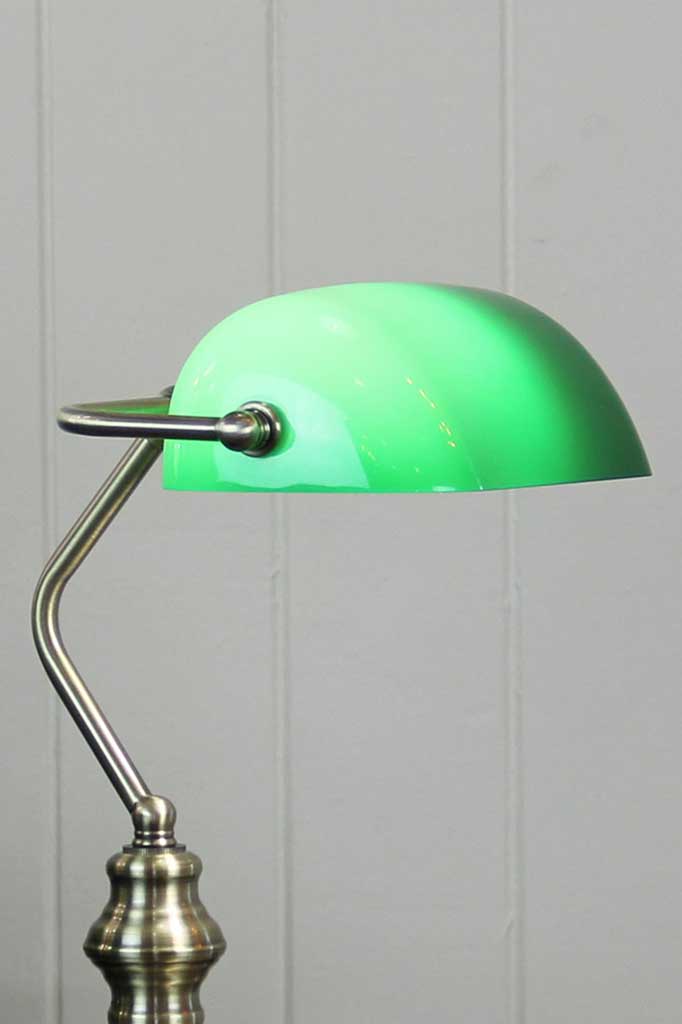 Close up of an Antique Brass Bankers lamp with green shade