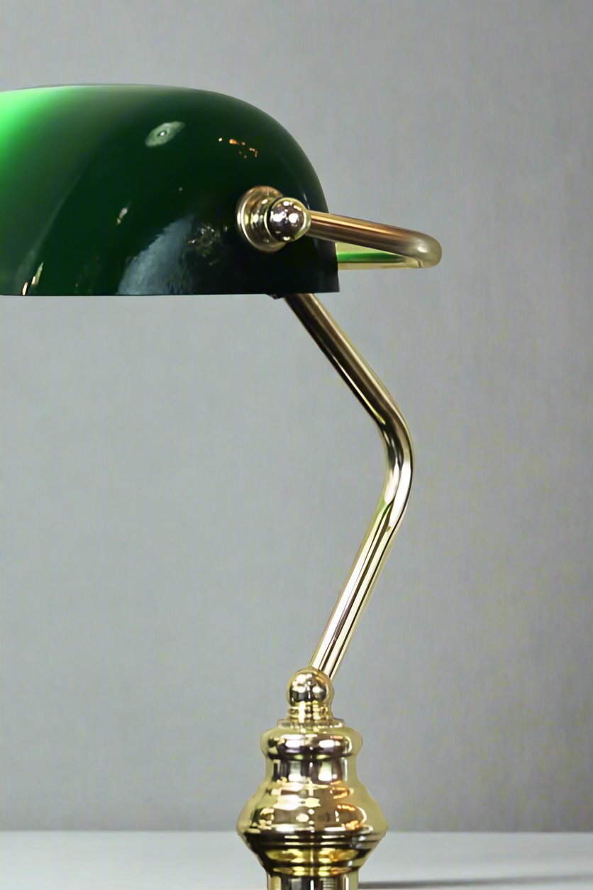 Close up of a Brass Bankers lamp with green shade