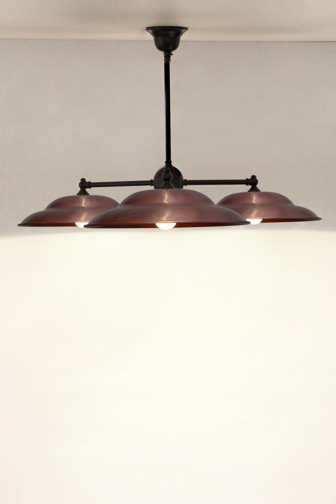 Barn shades in copper on a three arm fixture in black