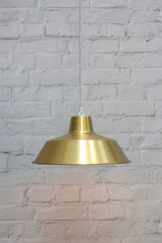 Bright brass pendant light with round white cord