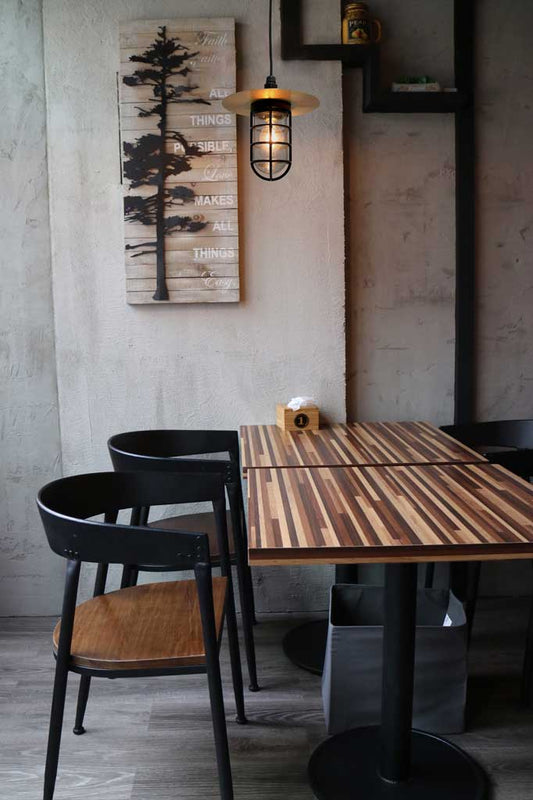 Bunker pendant with cage and gold disc in a restaurant