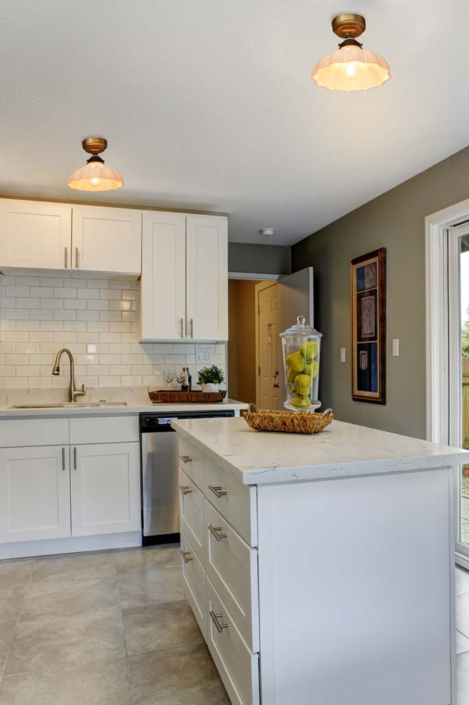 Two close to ceiling lights with opal finished vinatge shades, hanging over a kitchen bench. 