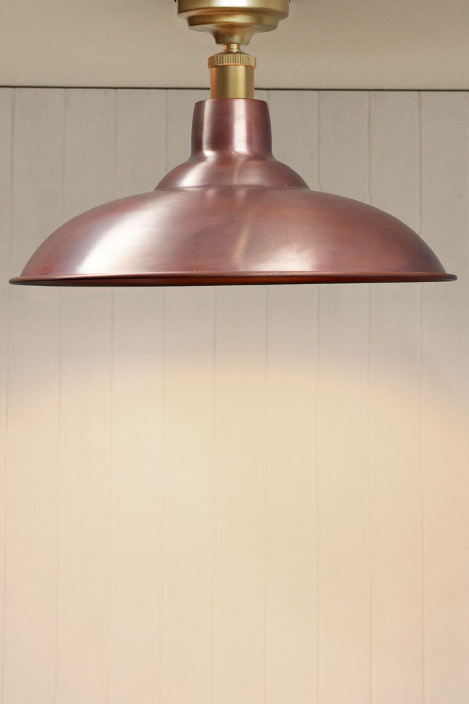 Aged solid copper barn shade on a gold/brass flush mount fixture. 