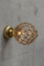 Clear glass ball wall light with rope detail on a gold/brass batten holder