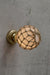 Opal glass ball wall light with rope detail on a gold/brass batten holder