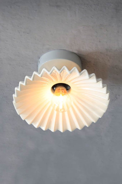 Flush mount ceiling light with glazed white ceramic shade and white batten holder. 