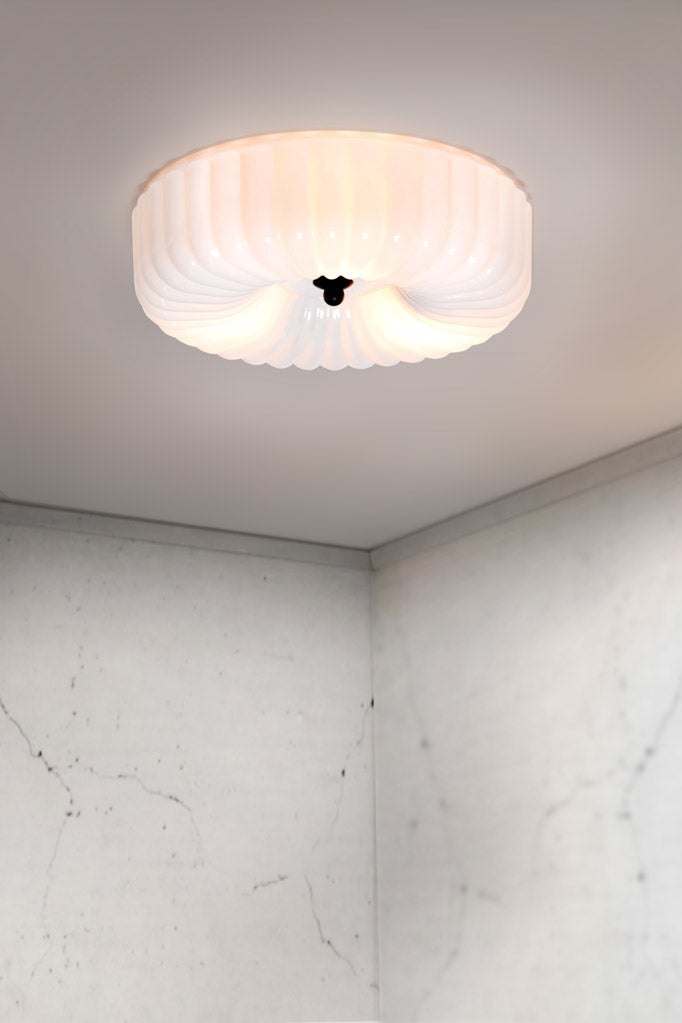 This light features an opal glass shade to diffuse and soften light. 