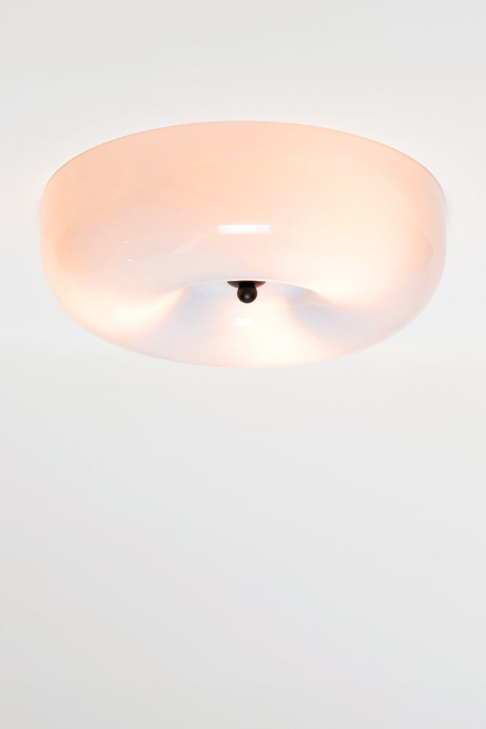 The shade is made from opal glass to diffuse and soften light.