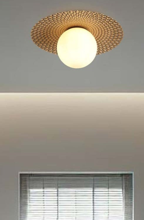 Maramingo Glass Ceiling Light in Black, has a gold metal flat design and opal glass ball shade above a window.