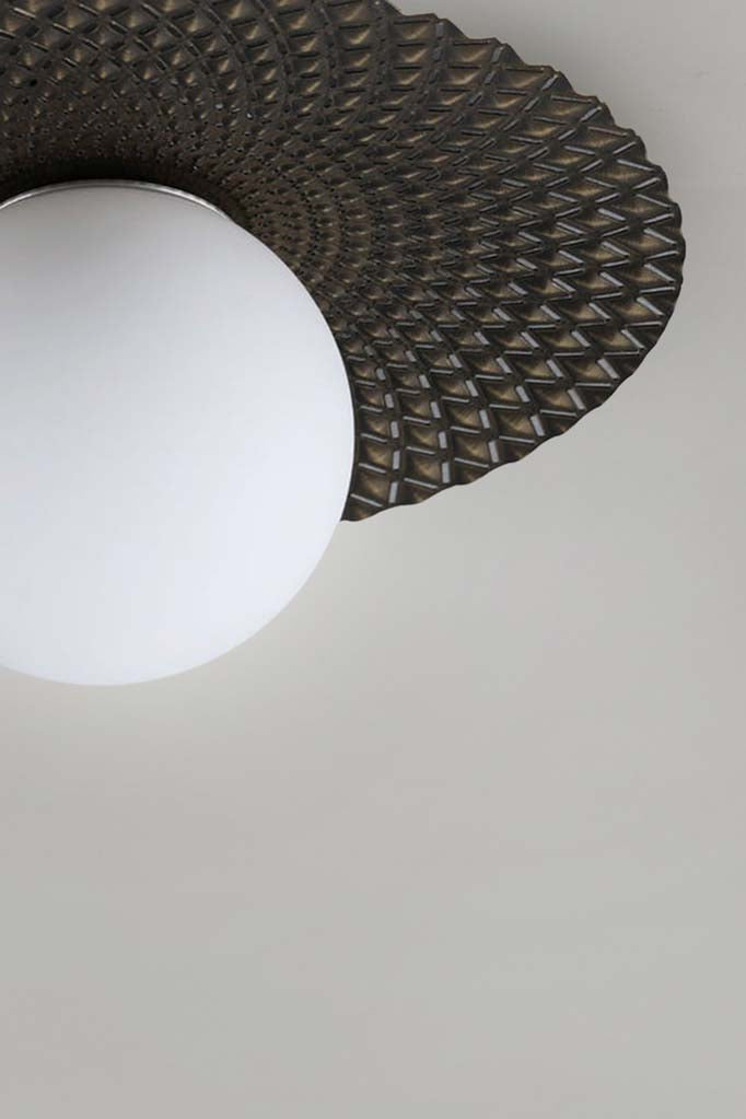 Close up of the Maramingo Glass Ceiling Light in Black, with a black/gold metal flat design and opal glass ball