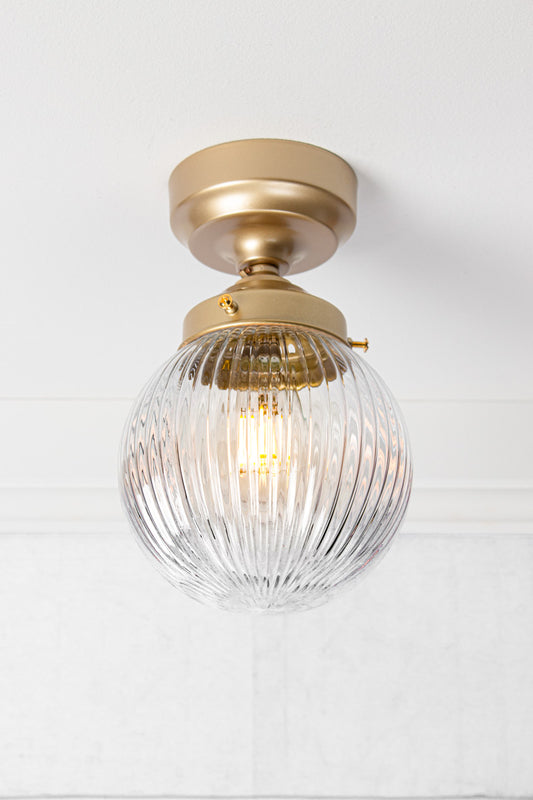 clear reeded glass ball batten light with gold/brass metalware