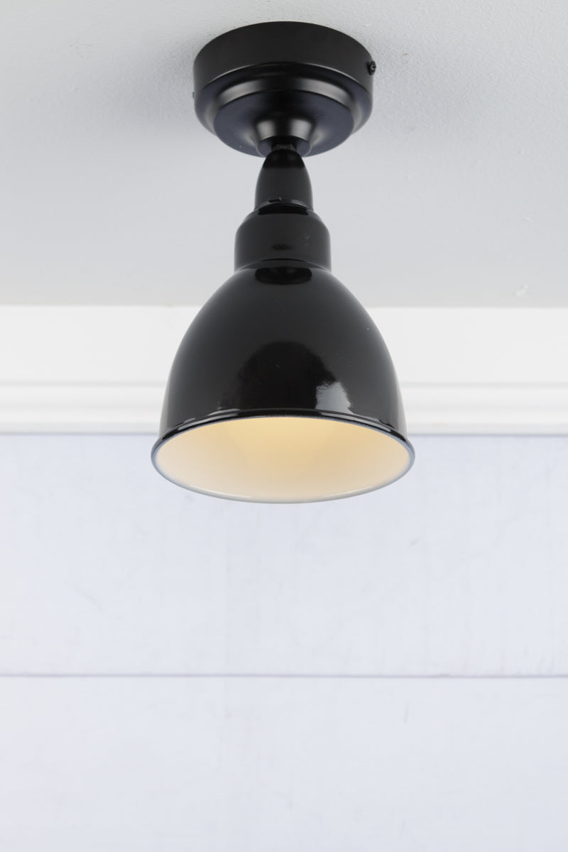 Black dome steel shade with white inner on an IP rated flush mount.