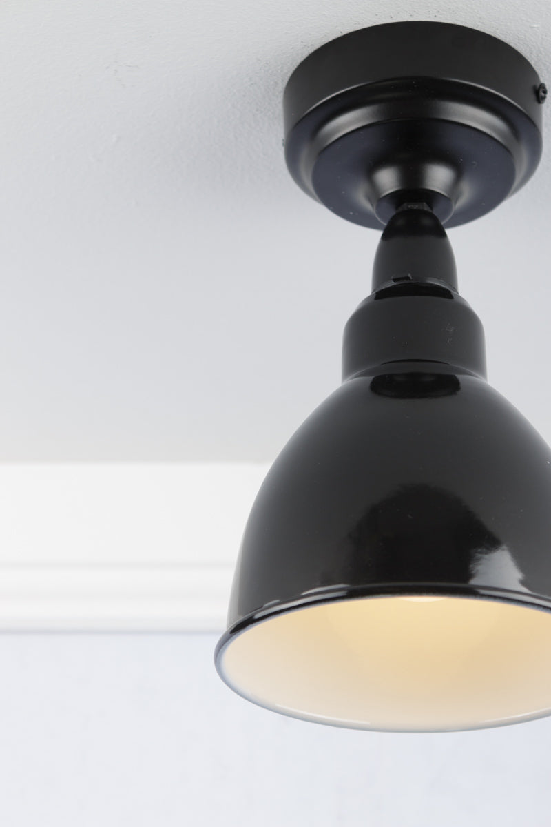 Black dome pendant flush mount light close up.