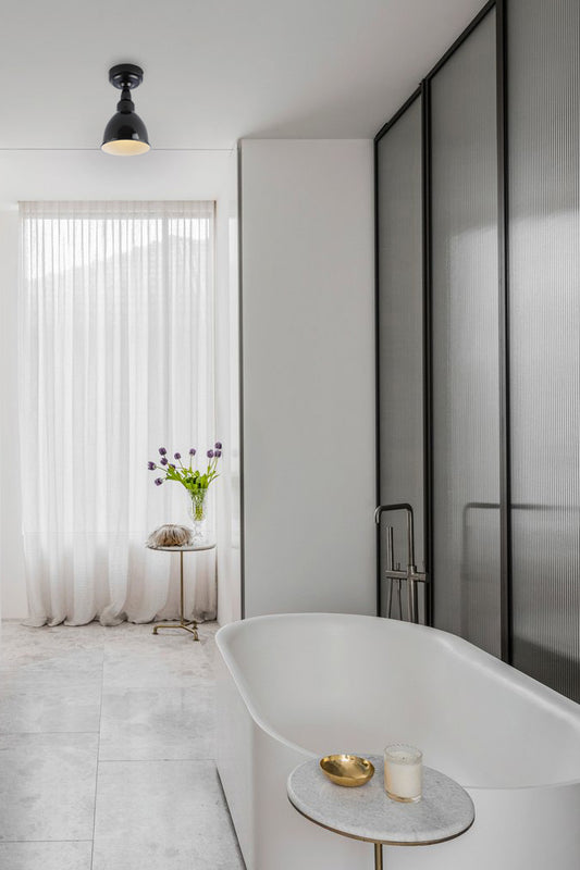 Black dome flush mount shade in a fesh white bathroom.