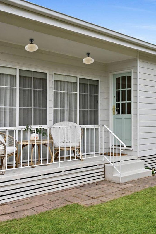 Two flushmount Coloma shades on a porch. 