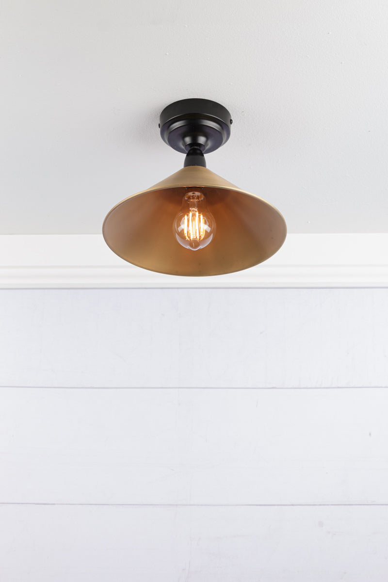 Small bright Aged brass cone shade on a black IP rated battenholder.