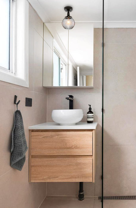 A clear reeded glass ball shade in a bathroom