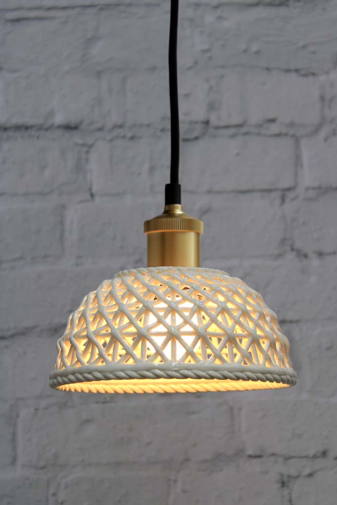 Small ceramic pendant light with gold/brass cord