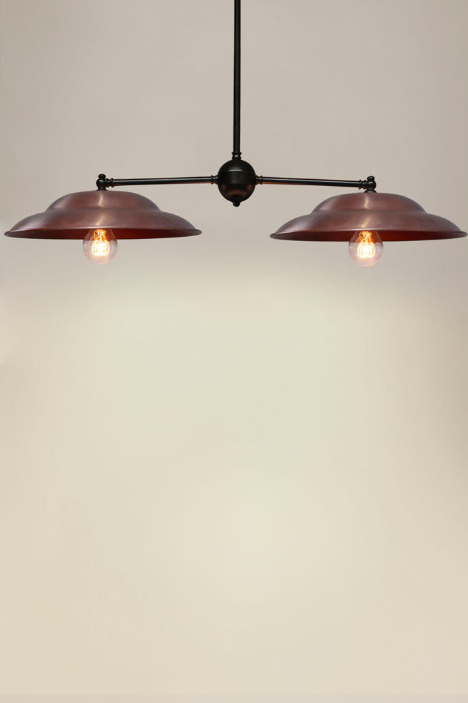 Barn Double Arm Pendant with black arm and copper shades.