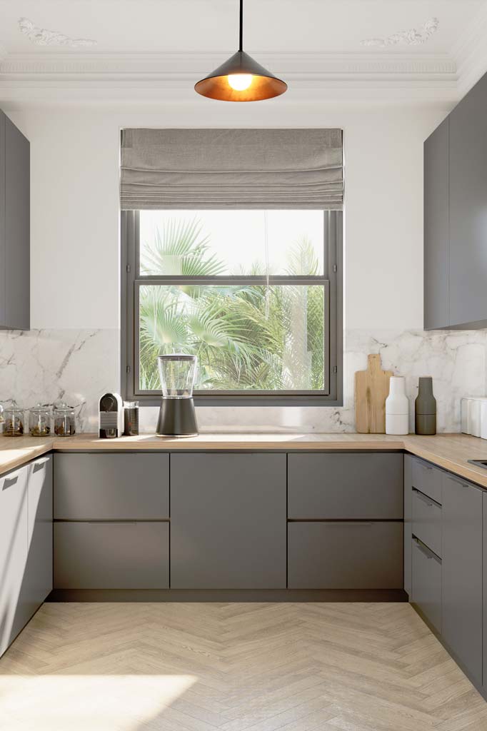 Brass cone pendant light hanging on a black pole in a fresh kitchen