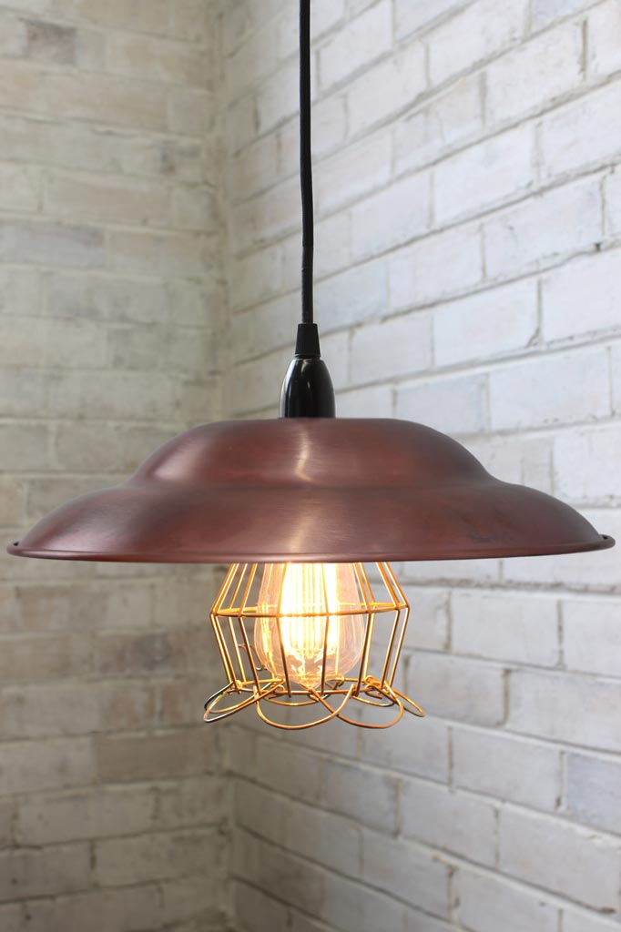 Barn Ball Trouble Light with black cord, copper shade and gold/brass shade.