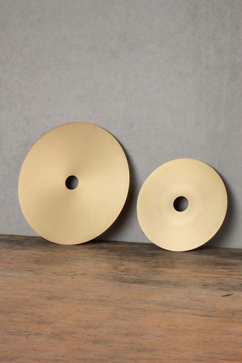 Small and large brass disc