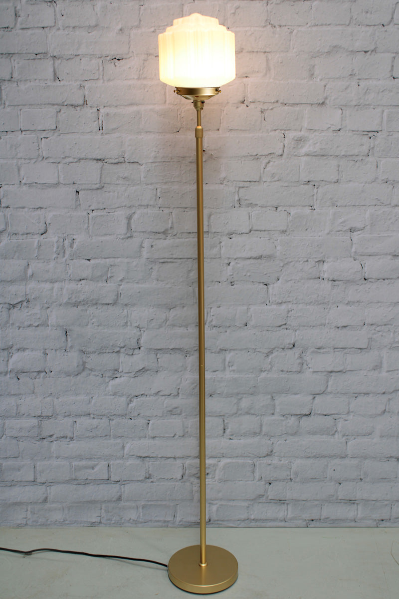 Deco schoolhouse shade on a gold/brass candlestick floor lamp. 