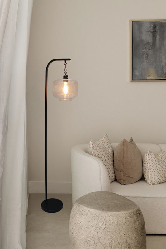 Black floor lamp with suspended square shade in a living room 