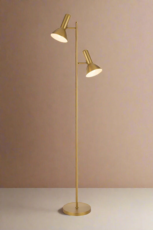 Twin floor lamp with brass finish.