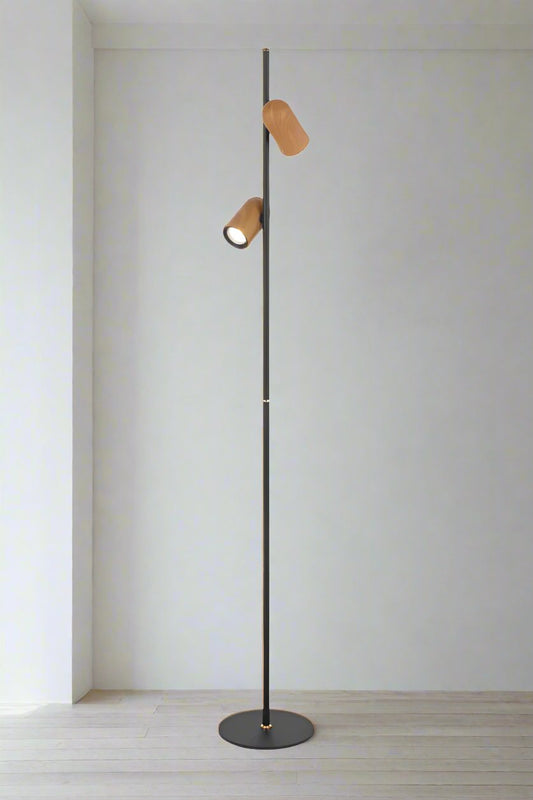 Twin floor lamp with wood look shades and a black stand.