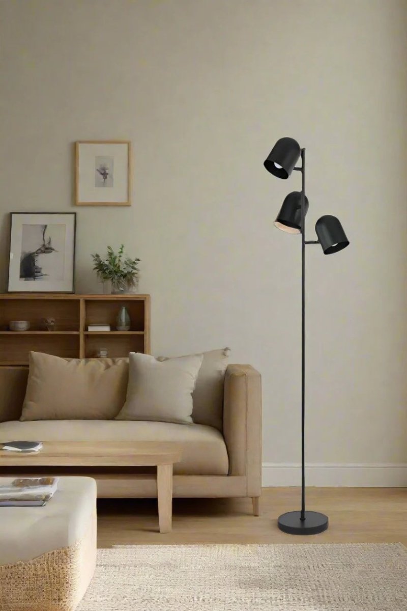 Black triple light floor lamp, in a lounge room. 