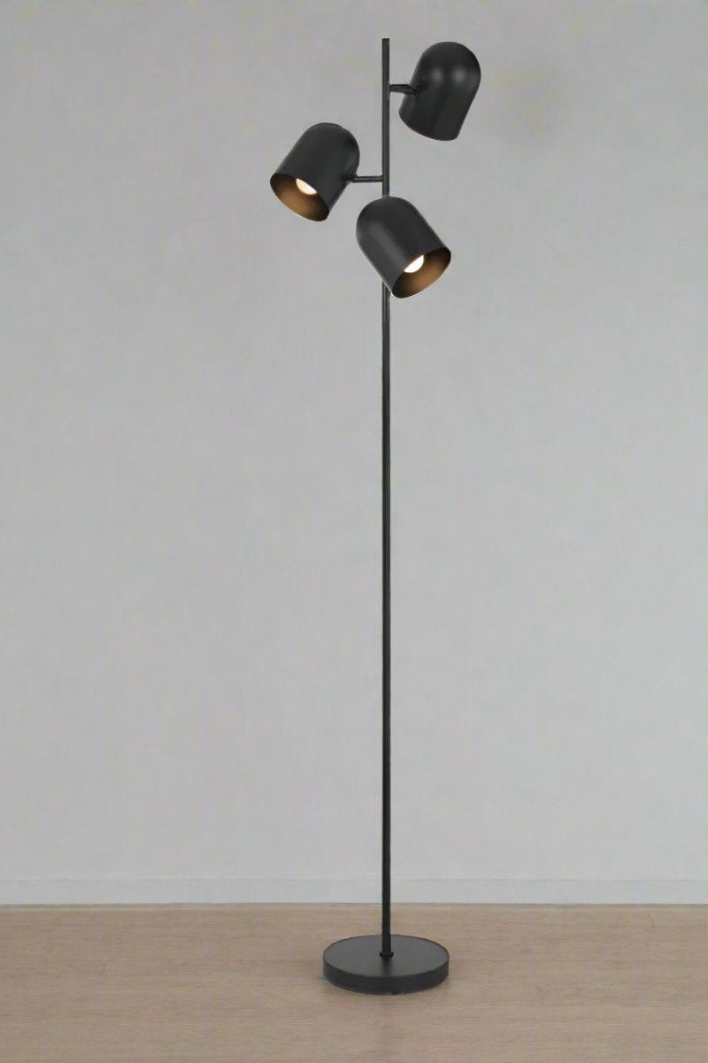 Black triple light floor lamp, lights on. 