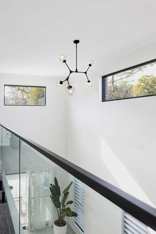 Five light dimpled glass chandelier inside of a house.