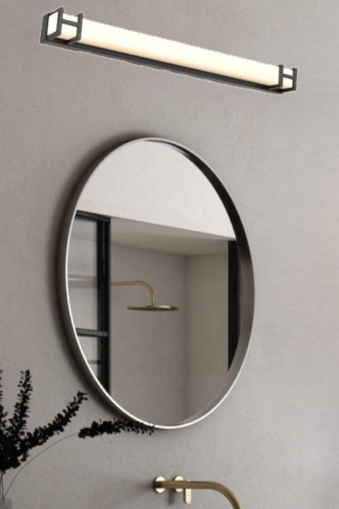 Black medium vanity wall light above a circular mirror