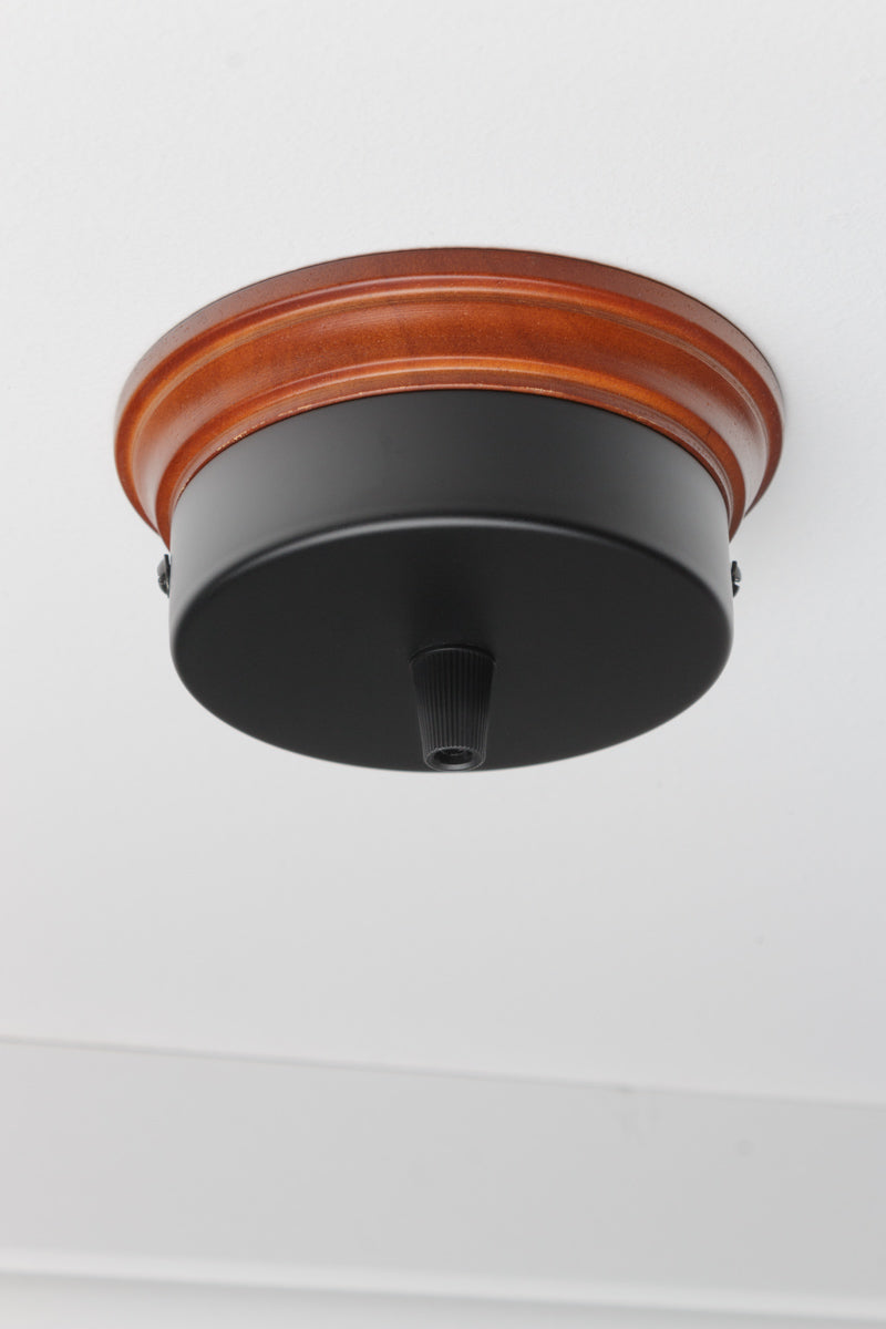 Blck flat ceiling rose with natural finished wood mounting block. 