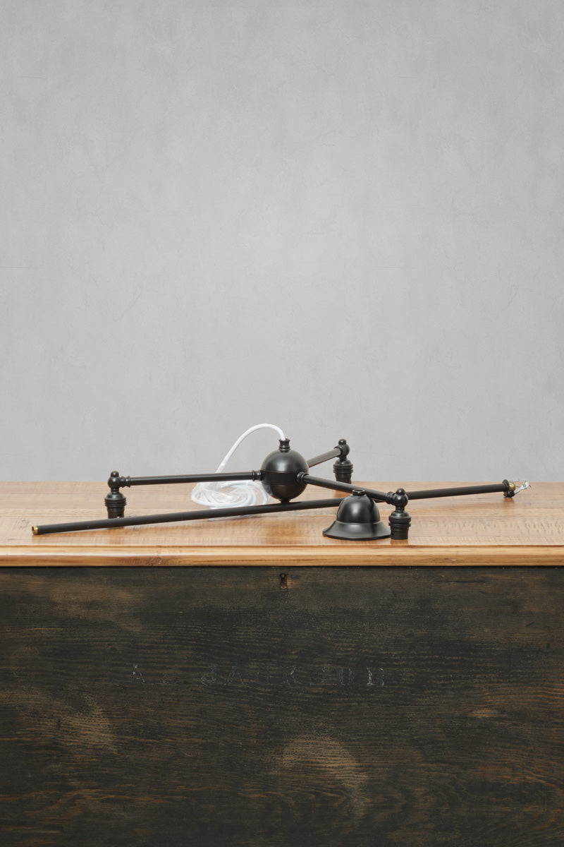 Brass triple arm fixture in matt black. 