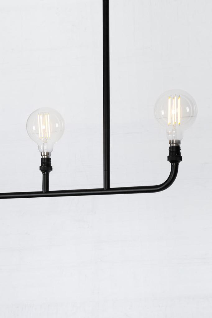 Close up of the Triple lamp linear chandelier in black. 