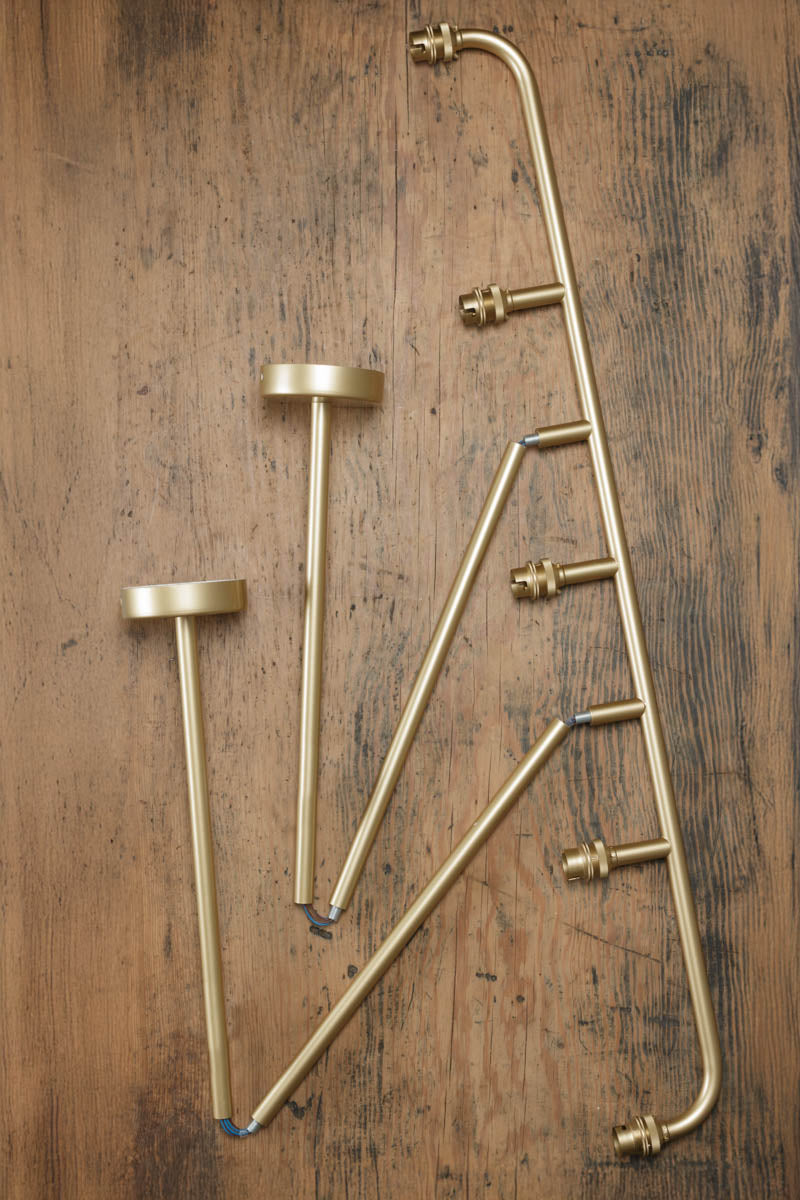 Deconstructed Five lamp linear chandelier in gold/brass. 