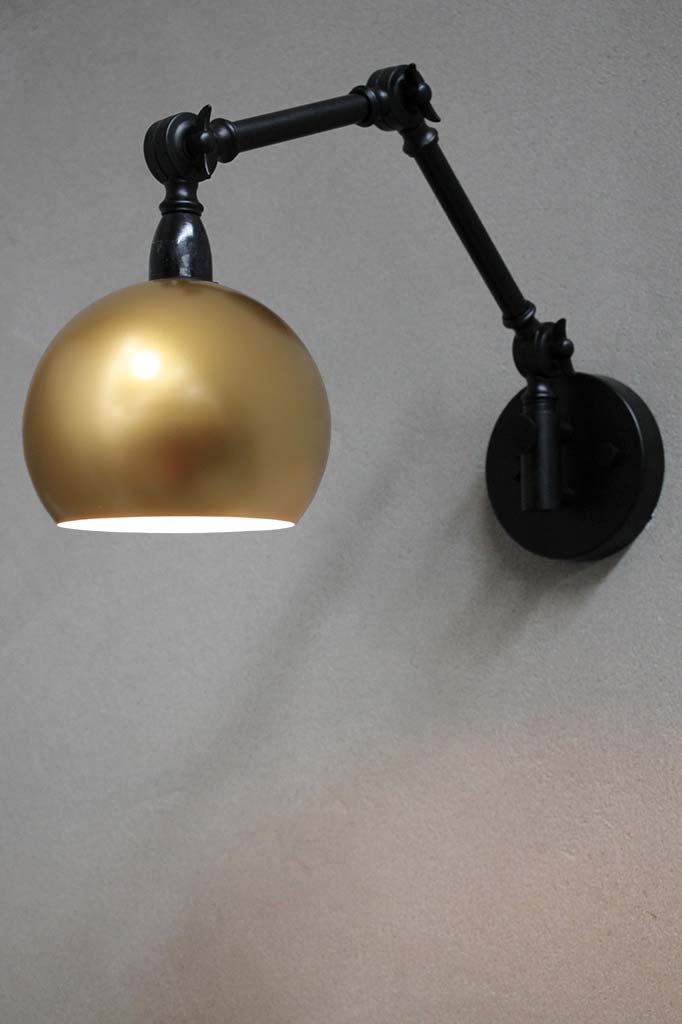 gold wall light with adjustable swing-arms for focused light