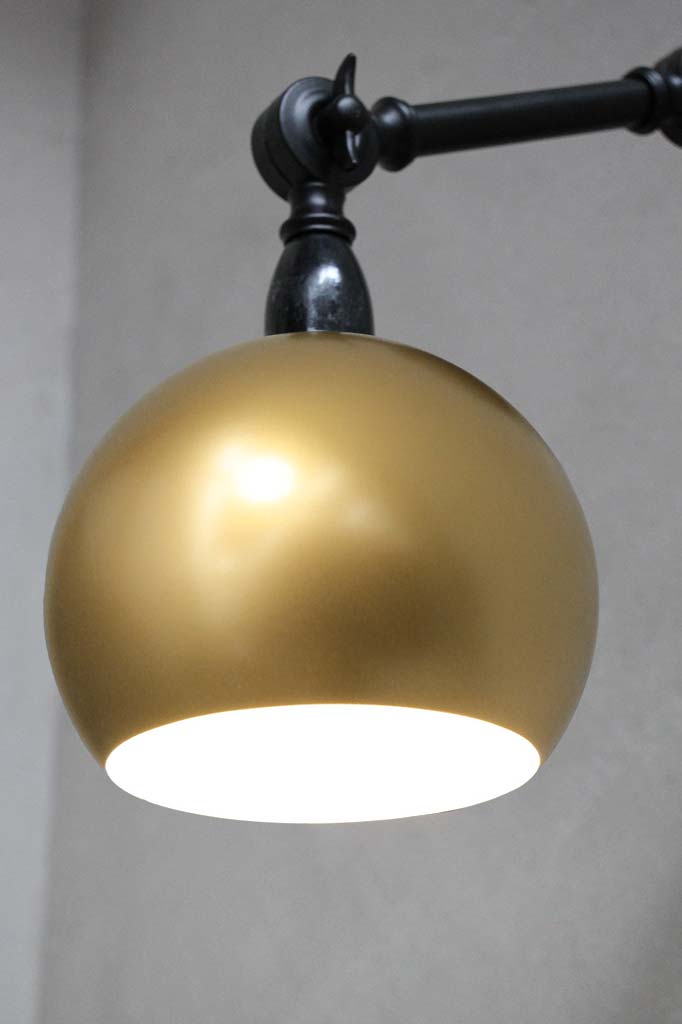 gold wall light with adjustable swing-arms for focused light