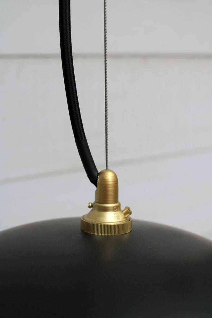 Close up of the black Dome shade with gold/black cord and cable suspension