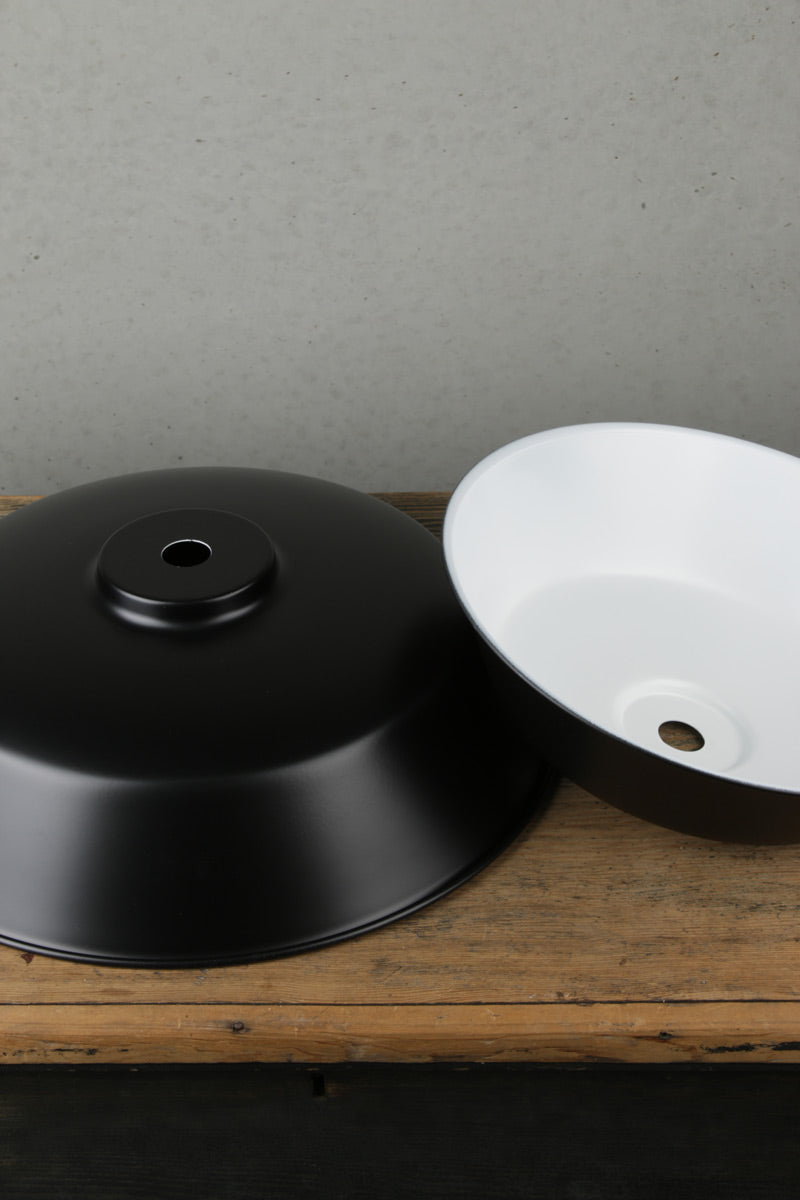 Small and large matt black station metal shades showing white inner. 