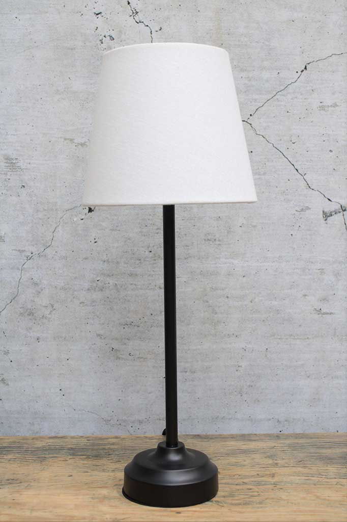 Black table lamp with white fabric shade not on