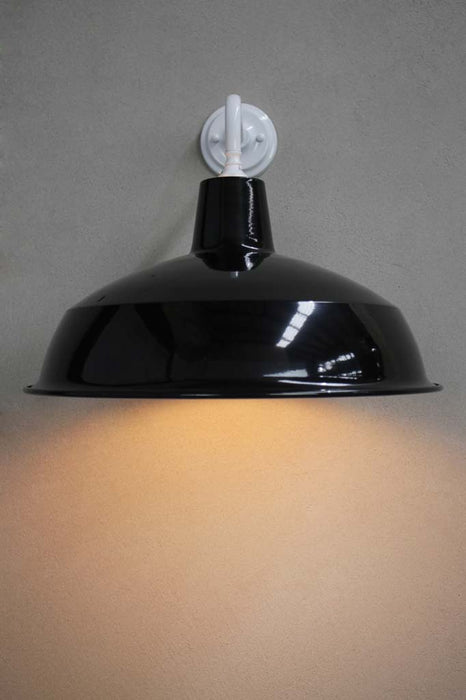 Front view of the Warehouse shade in black with white wall sconce.