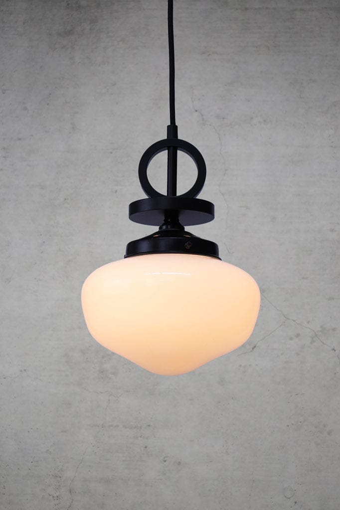 small opal glass pendant light with black disc cord with black gallery